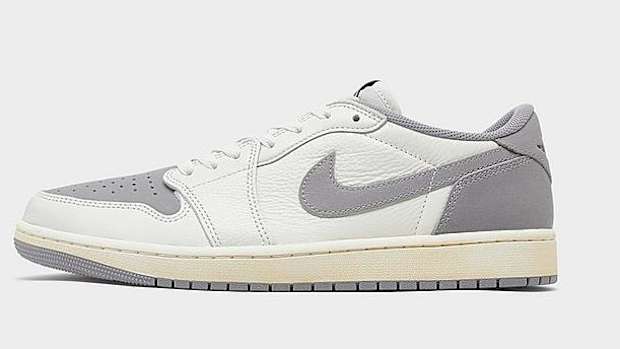 Side view of white and grey Air Jordan sneakers.